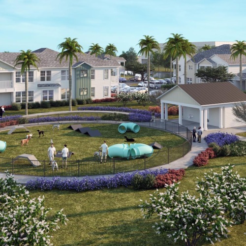 a large building with a dog park and people in front of it