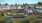 a large building with a dog park and people in front of it