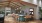 a large clubhouse with a kitchen and people watching different tvs