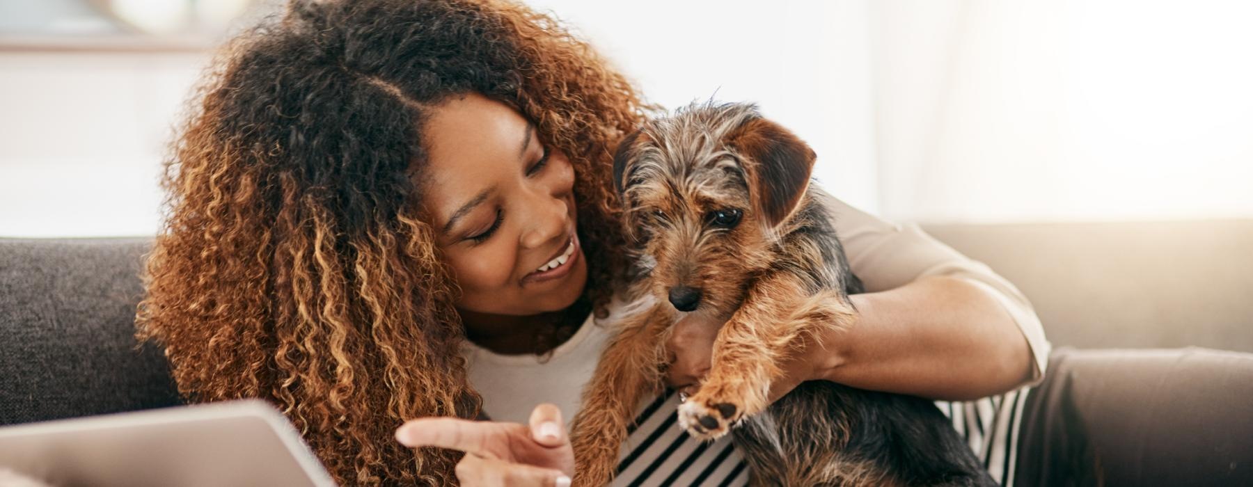 a person holding a dog on a couch