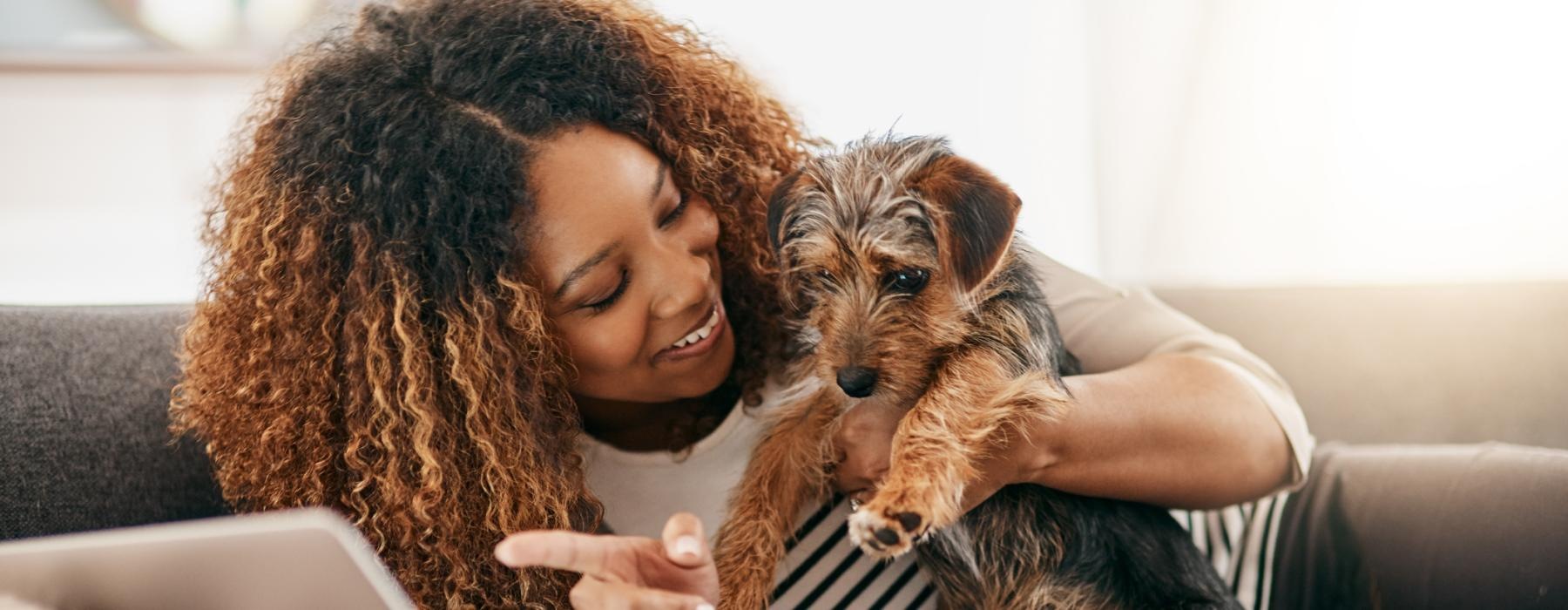 a person holding a dog on a couch
